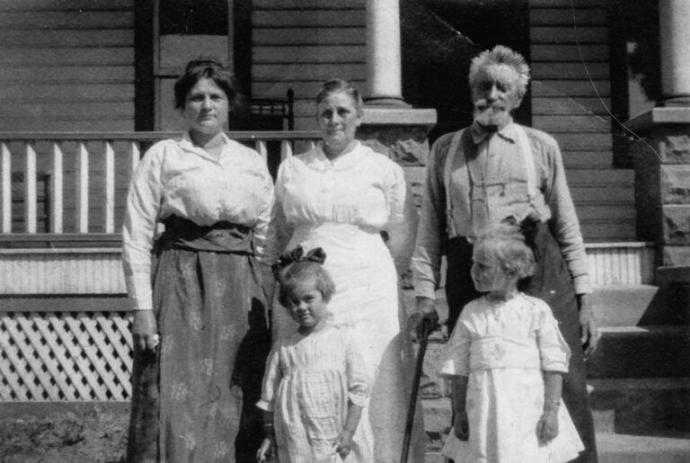 old black-and-white family photos being shown during a storytelling photography session in Colorado