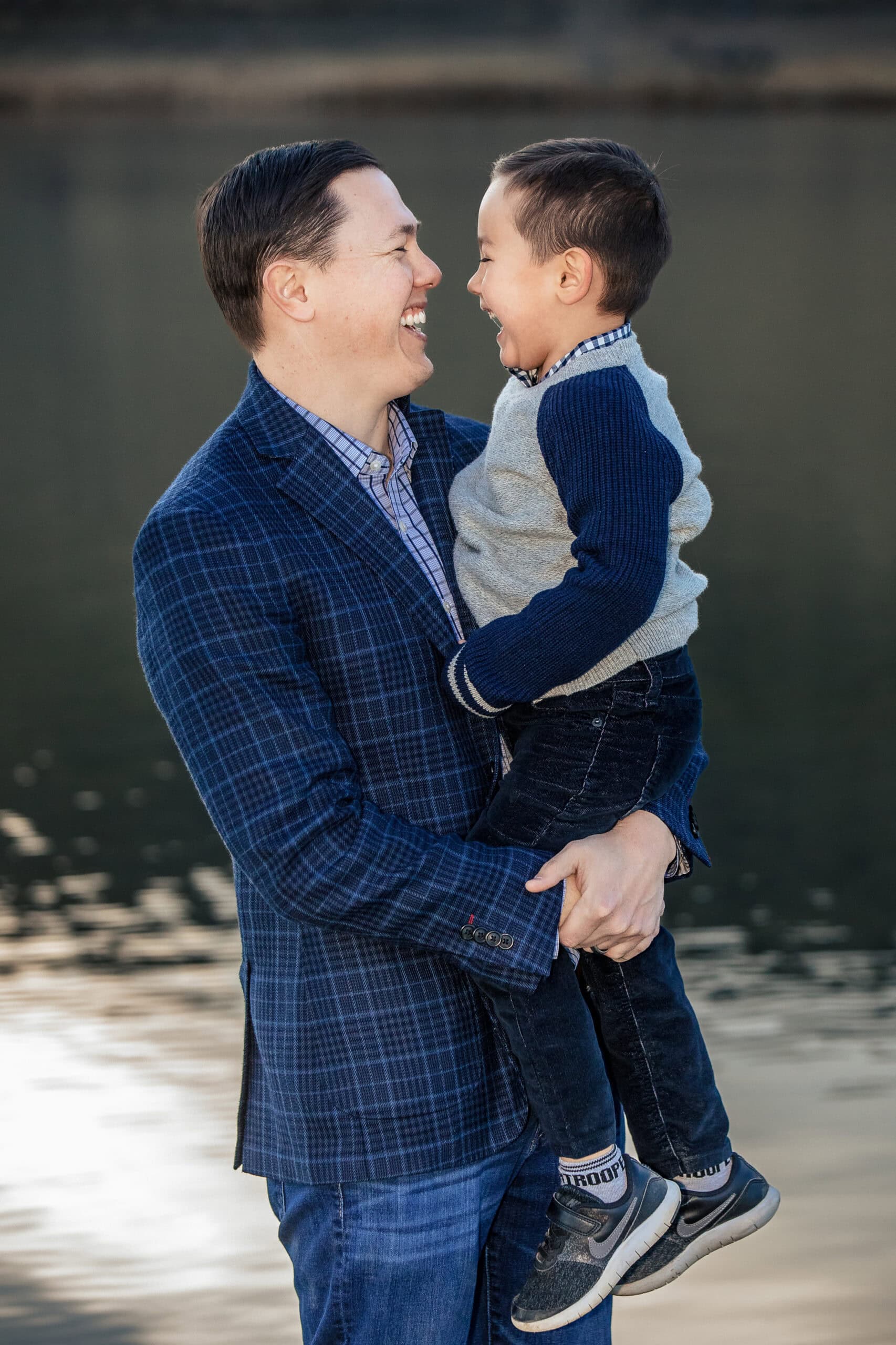 Father and son at a lake during their lifestyle family photography session.