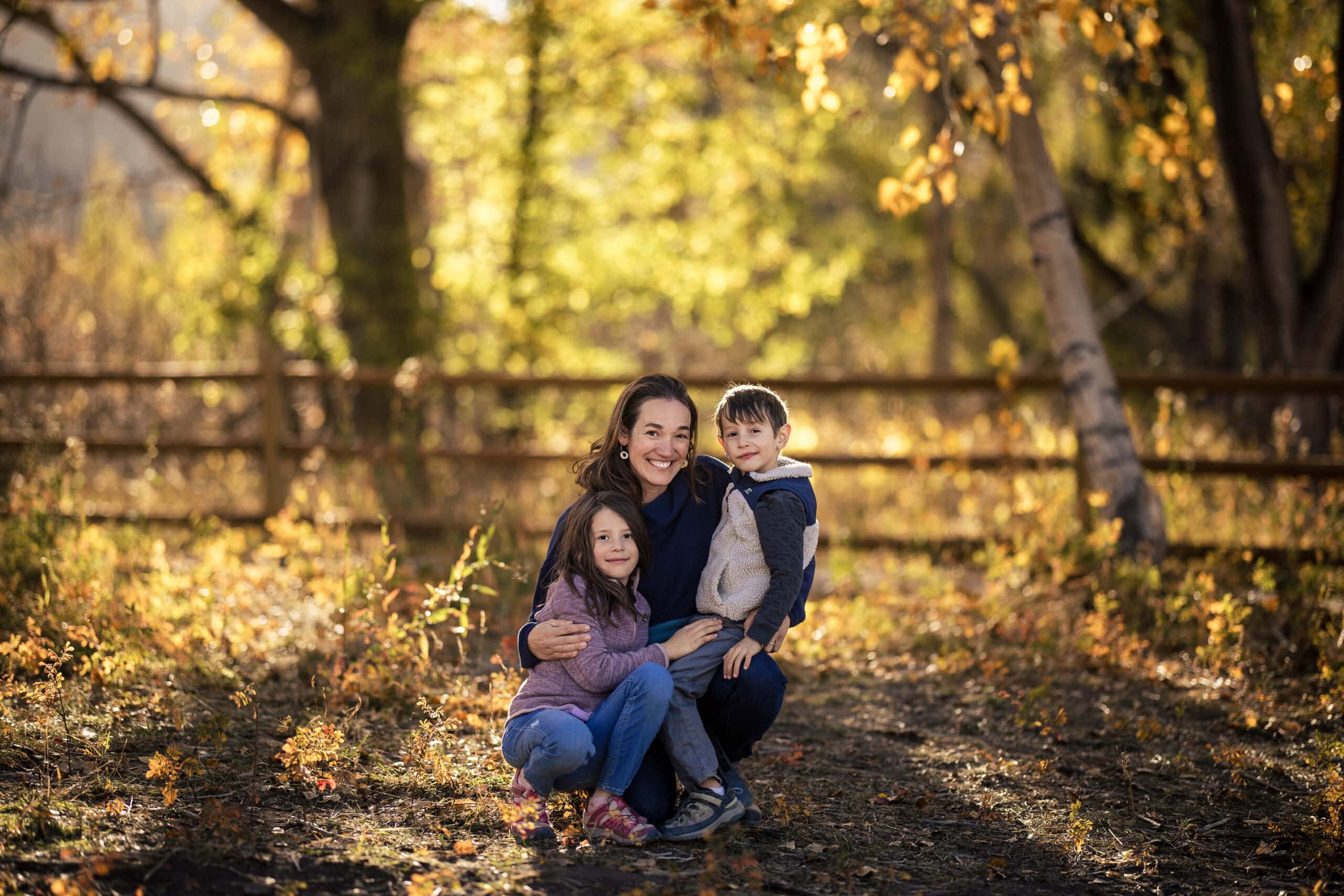 A mom and her son and daughter at the South Mesa Trailhead in Boulder Colorado A portrait of a family of four at the flatirons in Boulder Colorado during their lifestyle family photography session.