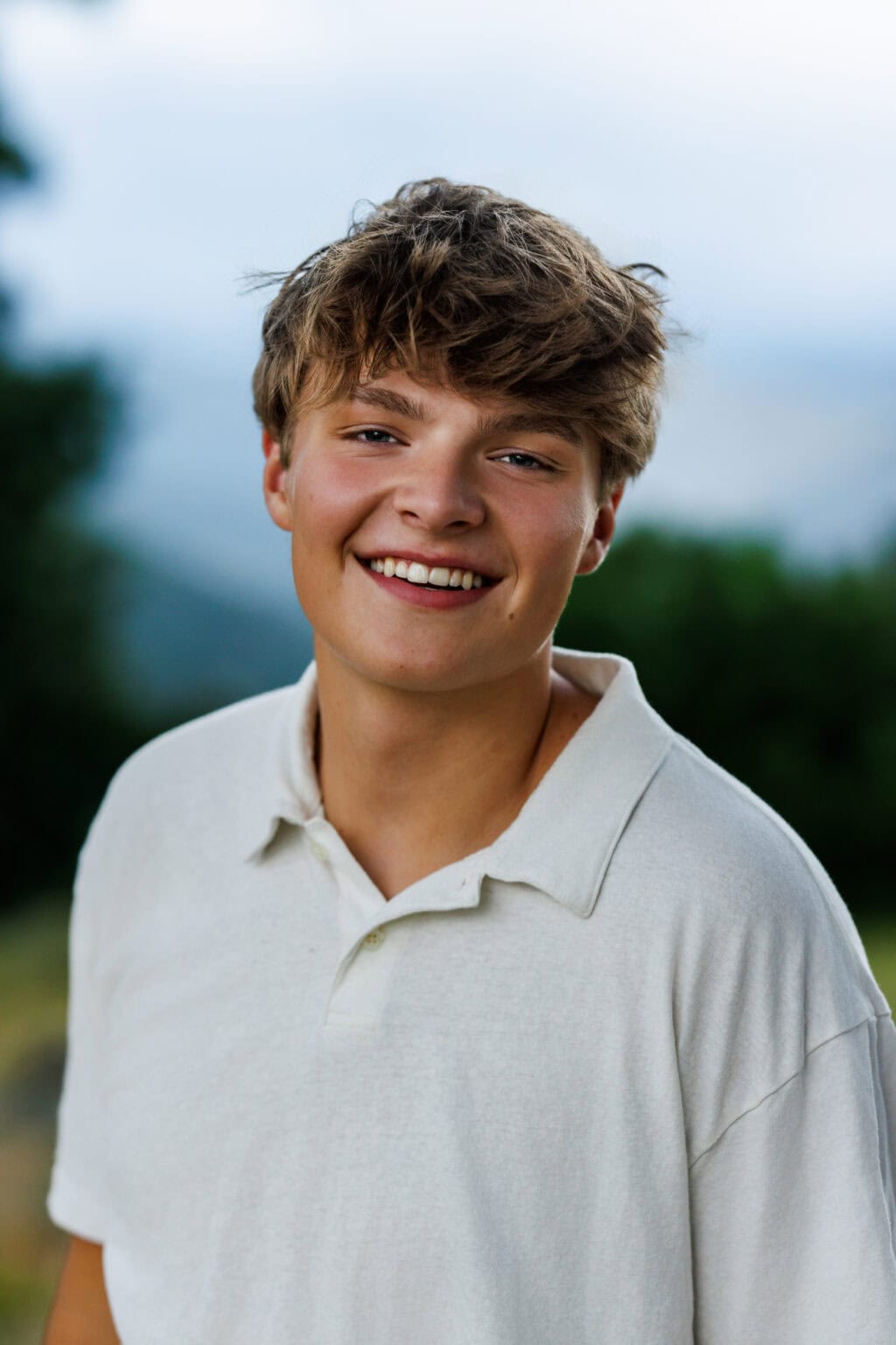 Colorado Senior Pictures portrait of smiling student outdoors in a light polo