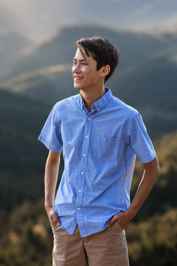 Colorado Senior Pictures of smiling young man in golden rolling hills