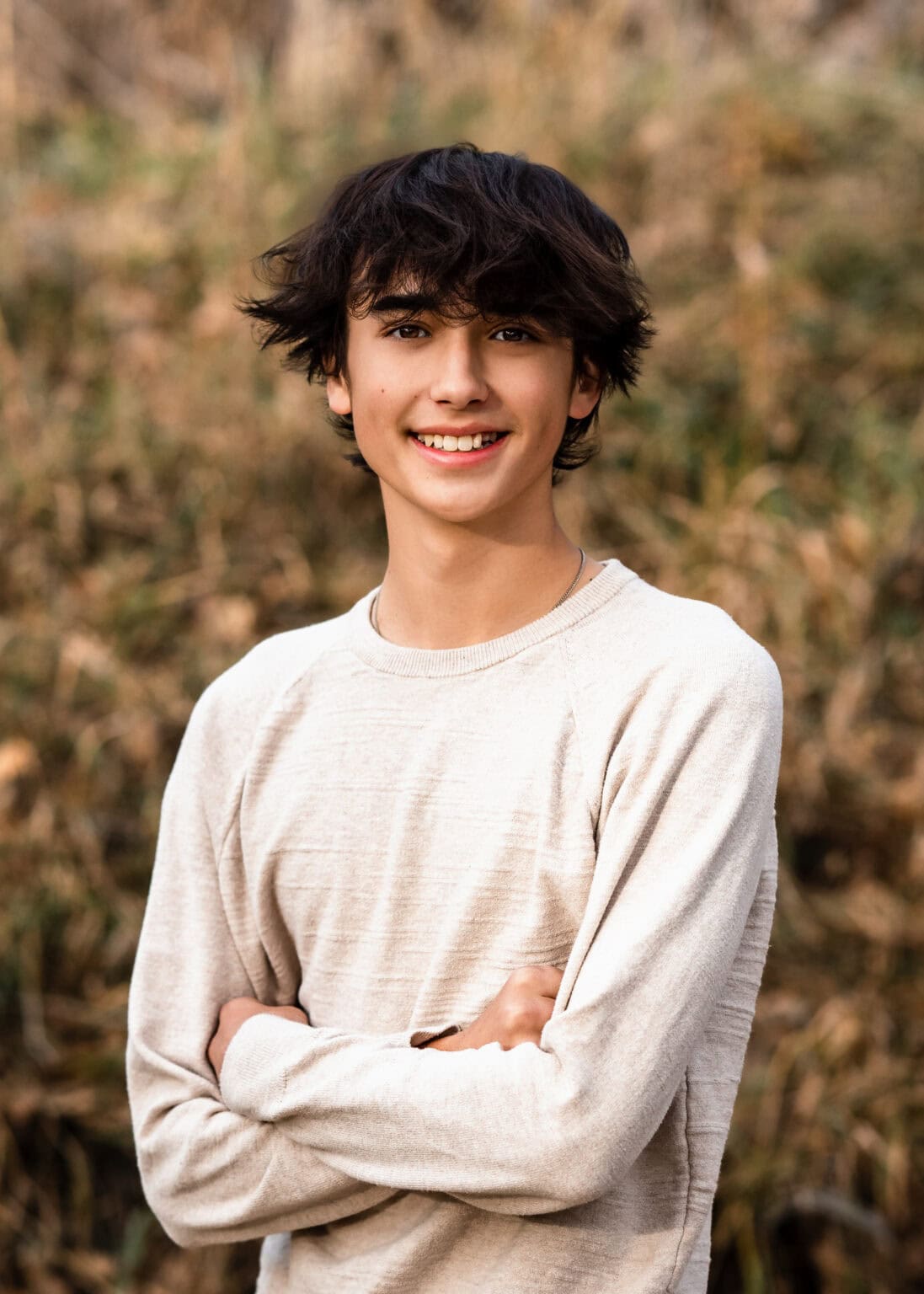 Colorado senior pictures of a smiling student outdoors in golden natural light.