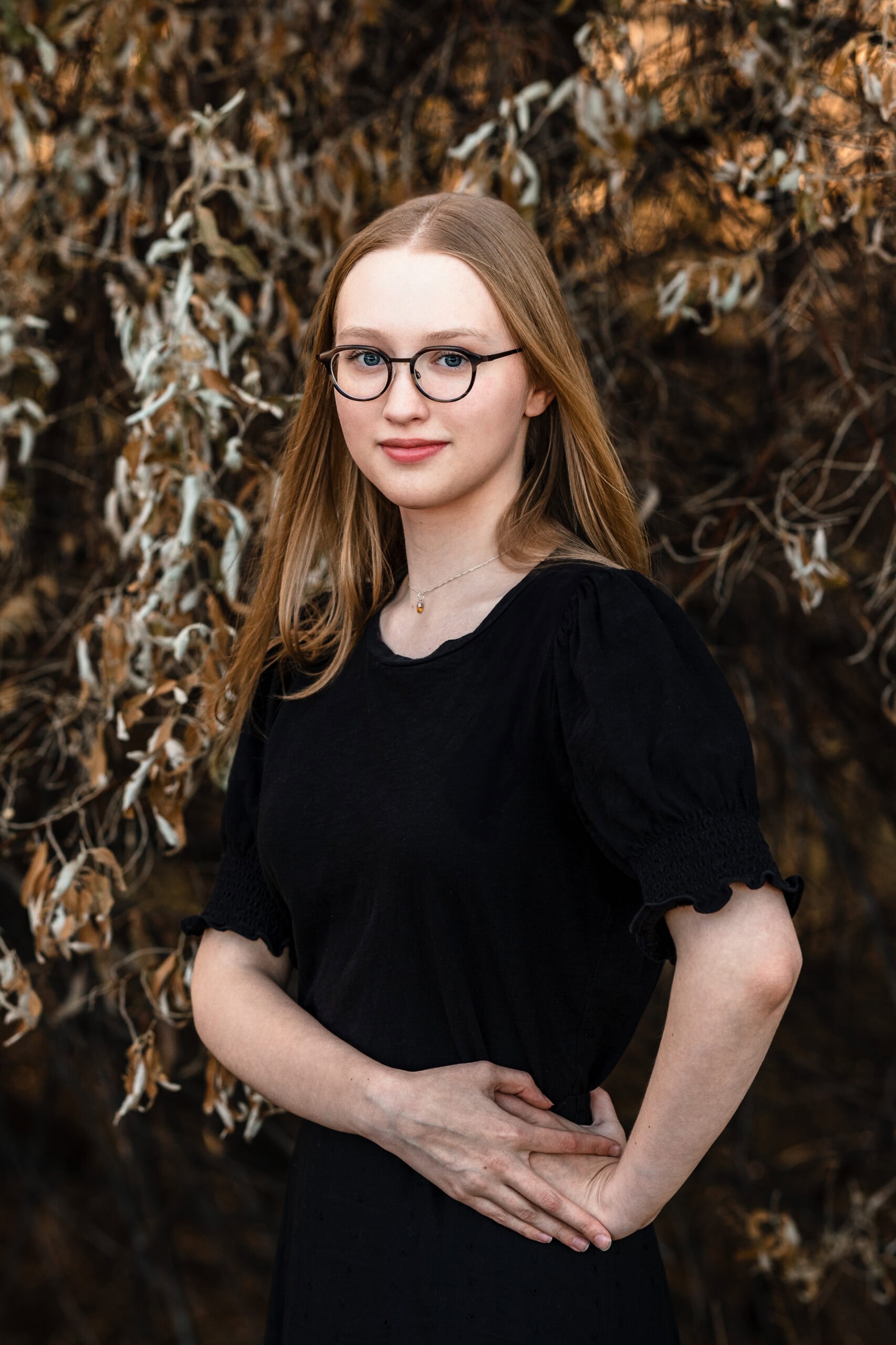 Colorado Senior Pictures featuring a young woman in a black dress and round glasses
