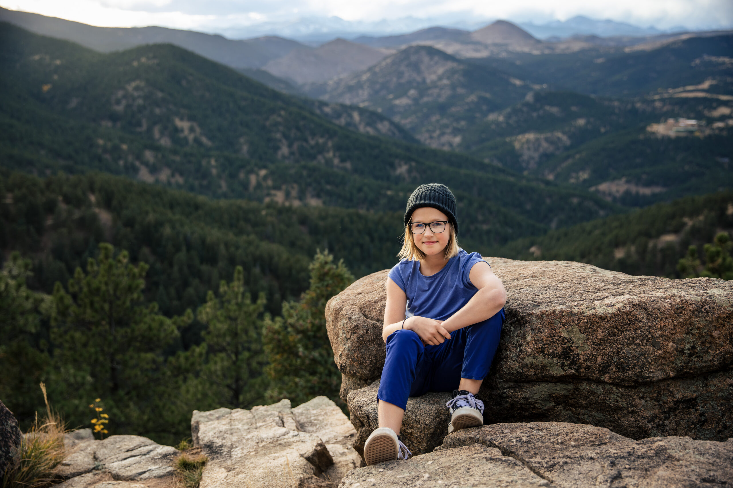 School Picture Day portrait with a smiling person on a scenic mountain overlook.