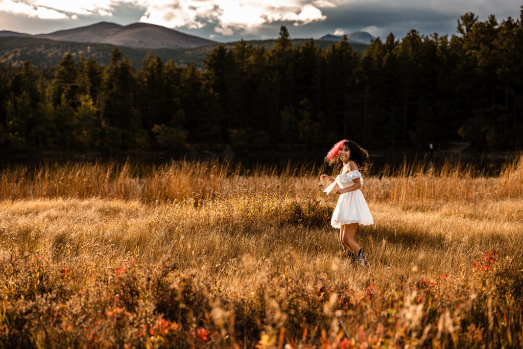 Senior photographer Boulder Colorado portrait of girl in white dress in golden meadow