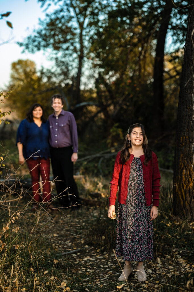 Fall Family Mini Sessions Colorado portrait of daughter and parents in Boulder woods