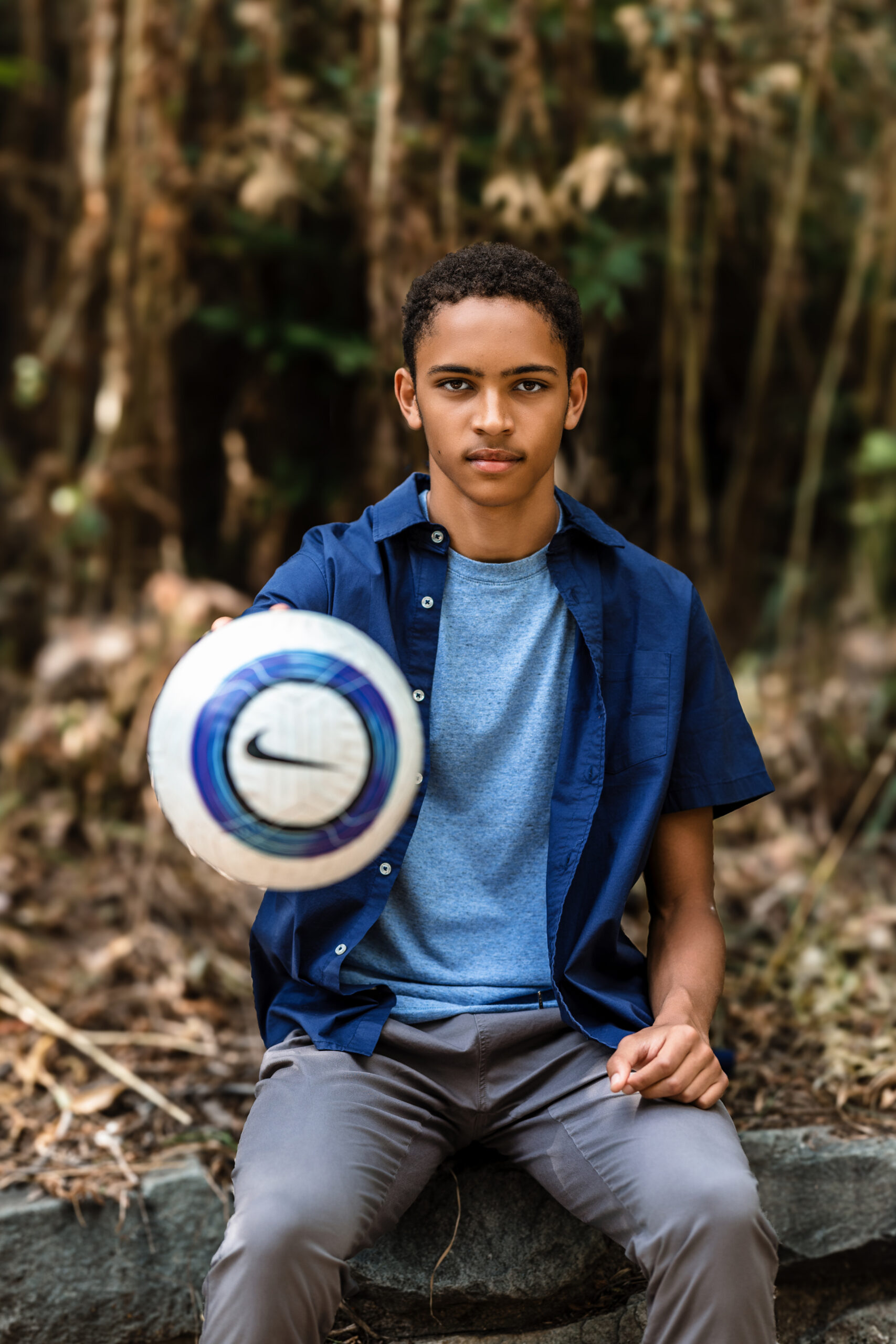 Monarch High School senior holding a soccer ball during his portrait session in Boulder, Colorado