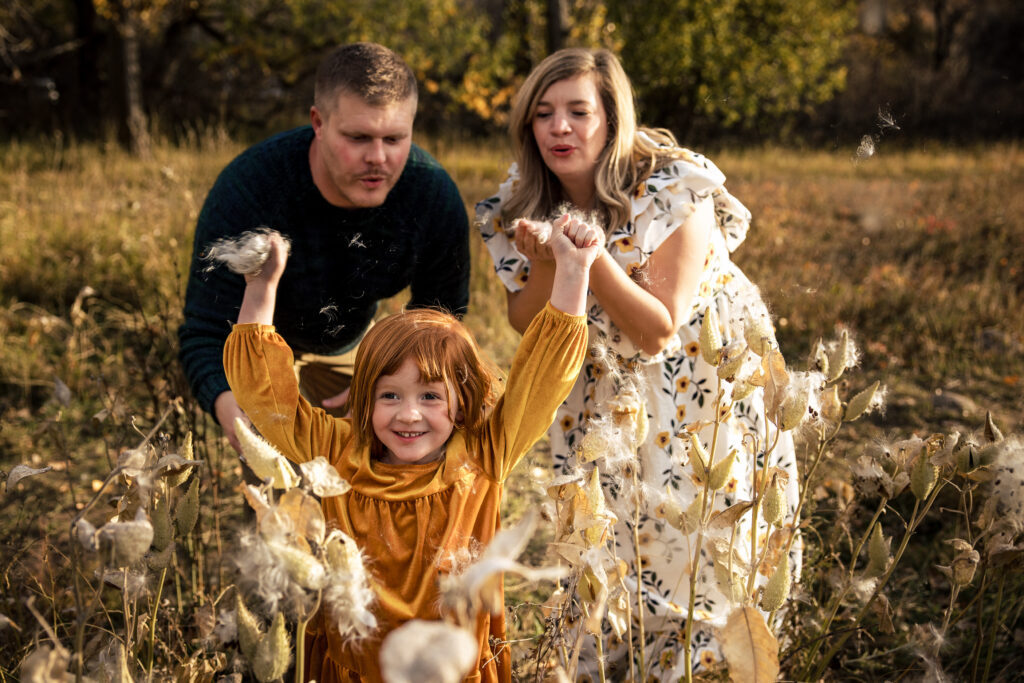 Colorado fall family mini sessions with joyful child and parents in autumn grasses