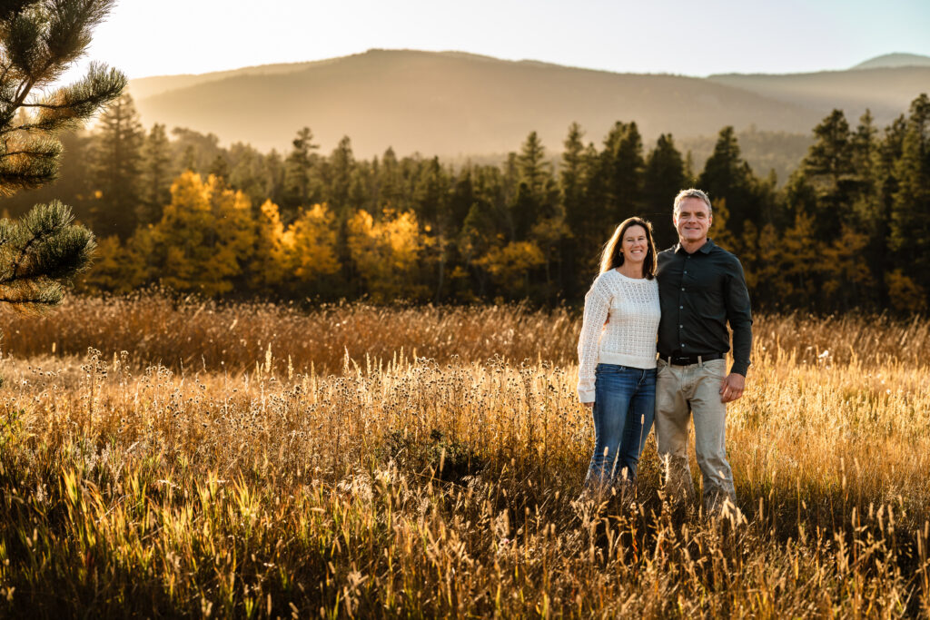 Couple in golden meadow for Fall Family Mini Sessions Colorado